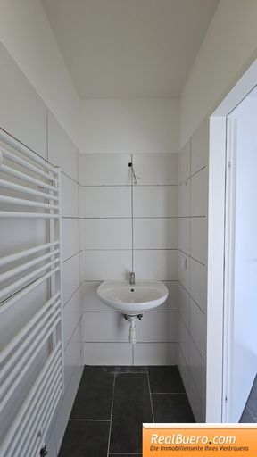 Badezimmer mit Dusche und Handwaschbecken