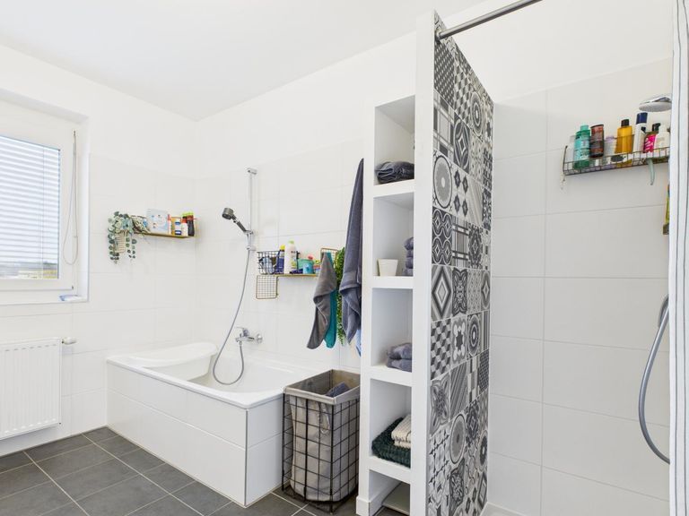 Badezimmer mit Badewanne und Dusche