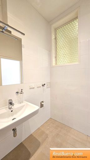 Badezimmer mit Wanne, Handwaschbecken, Handtuchtrockner, Waschmaschinenanschluss