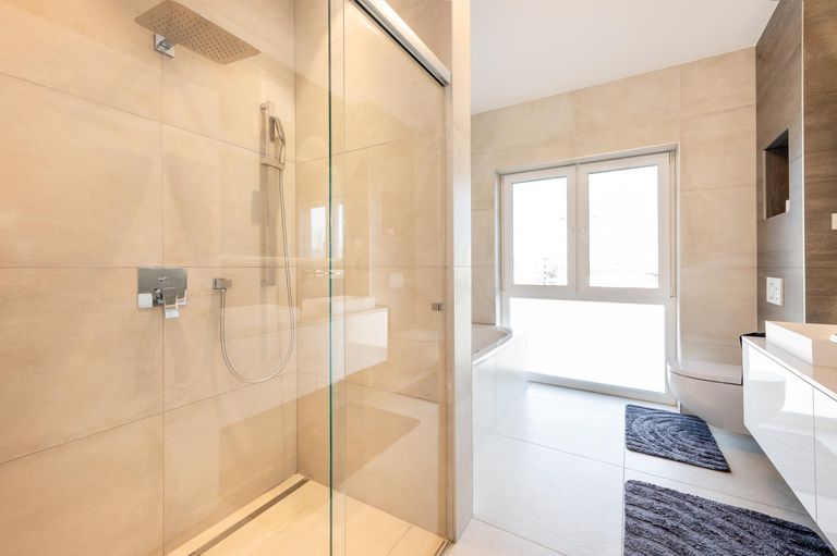 Badezimmer mit Walk-In Dusche, Badewanne und WC